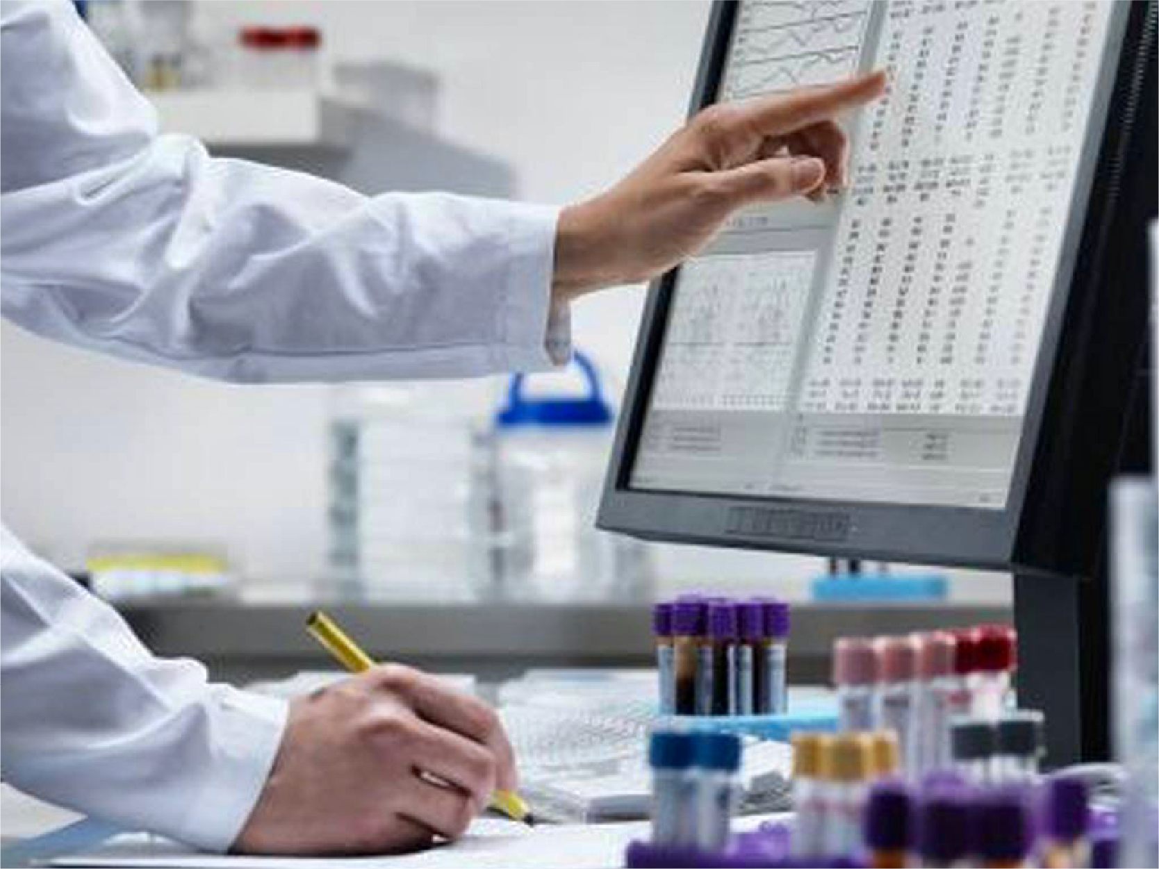 This is a photo of a lab technician working with test tubes and analyzing data to represent the STCC's Cancer Databases and Tissue Banks platform.